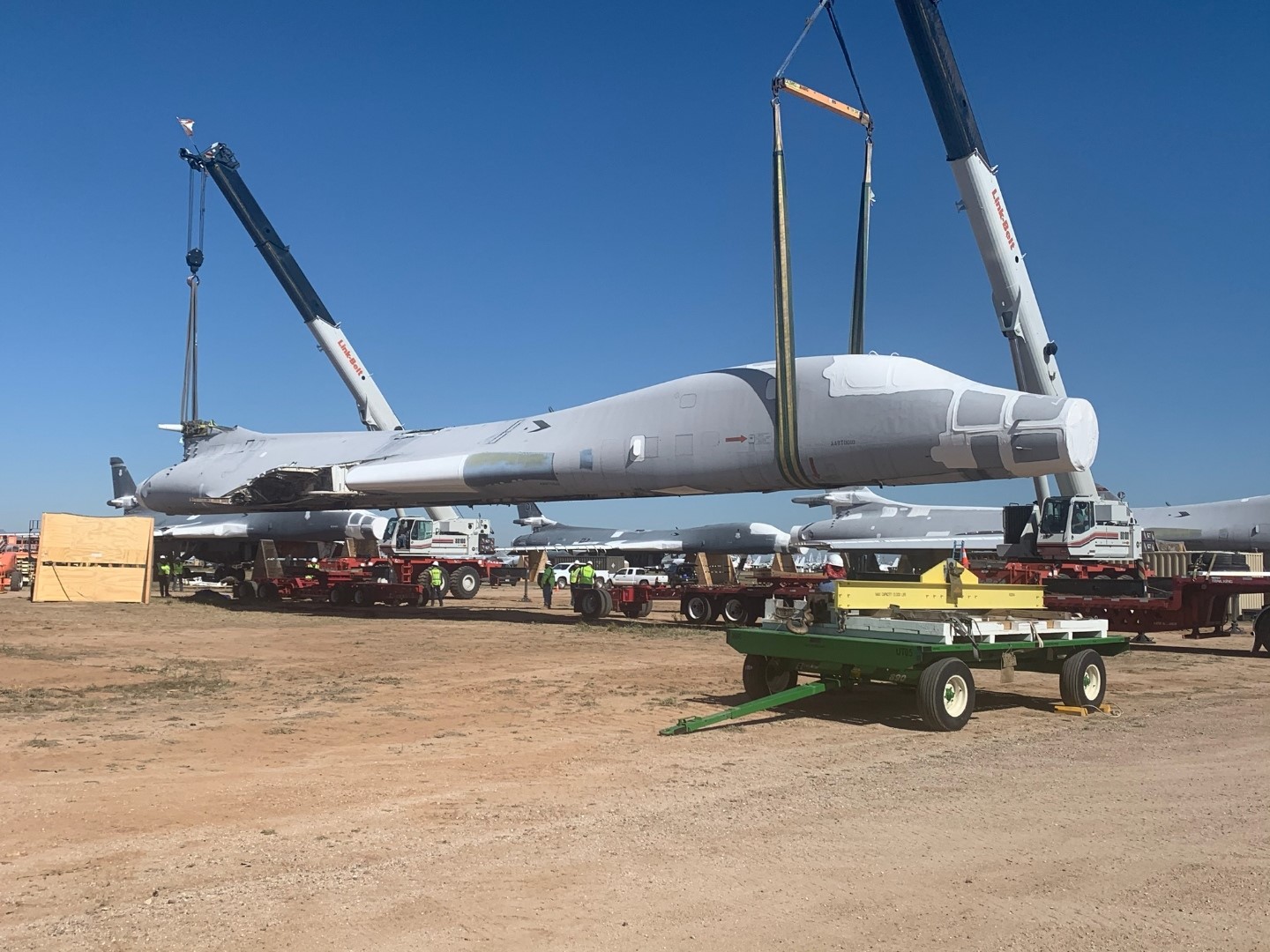 B-1B Lancer tail number 85-0092 is lifted and placed on flatbed trailers for the 1,000-mile journey to Wichita, Kan., April 24, 2020. The National Institute for Aviation Research at Wichita State University will scan every part of the aircraft to create a digital twin that can be used for research. (U.S. Air Force photo by Daryl Mayer)