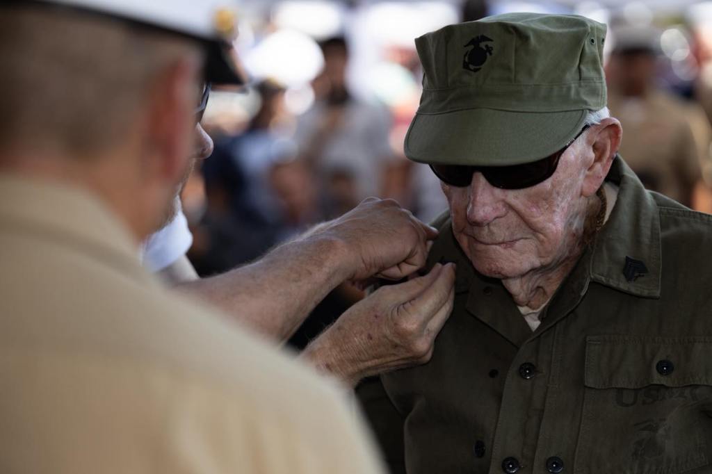 He was bayoneted in Guam. Shot on Iwo. Now, at 100, he is a sergeant.