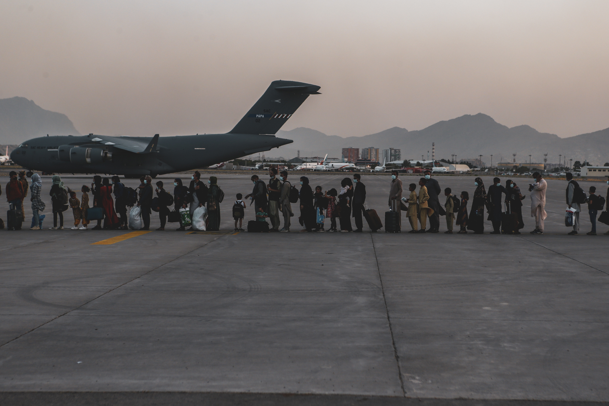 Evacuees wait to board a Boeing C-17 Globemaster III during an evacuation at Hamid Karzai International Airport, Kabul, Afghanistan, Aug. 23, 2021.
