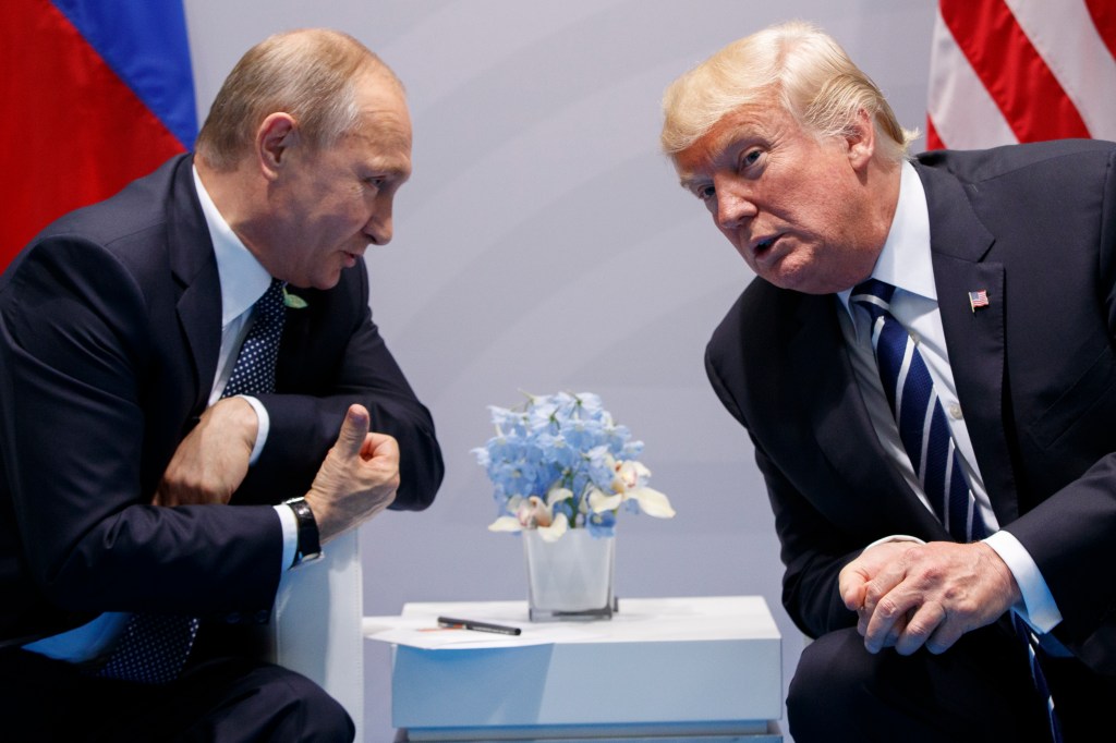 Trump confronts Putin on election hacking in first meeting